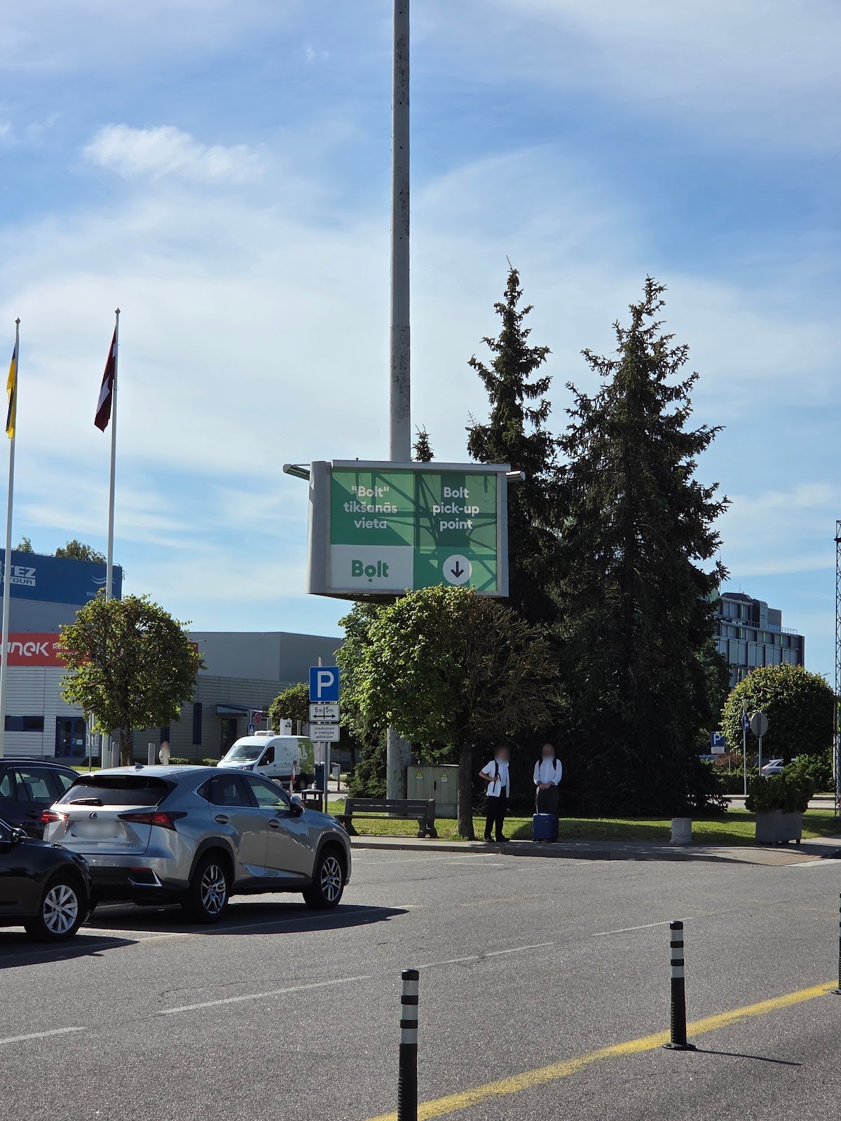 A large airport billboard indicating the taxi pickup point for arriving passengers.